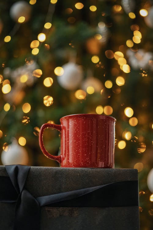 Red Ceramic Mug on Gray Present Box with Black Ribbon