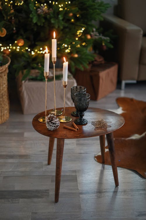 White Candles on Brown Wooden Round Table