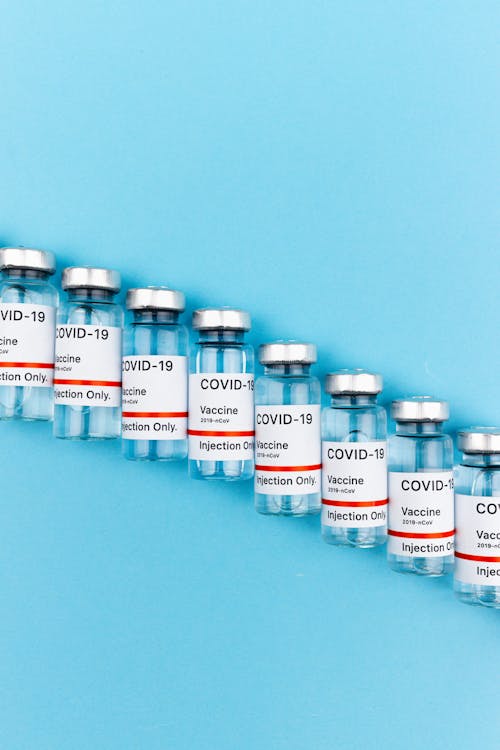 Lined Up Covid Vaccines on Blue surface