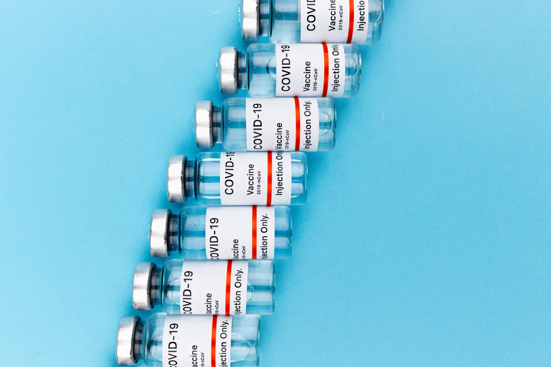 Vaccine Bottles on Blue Background
