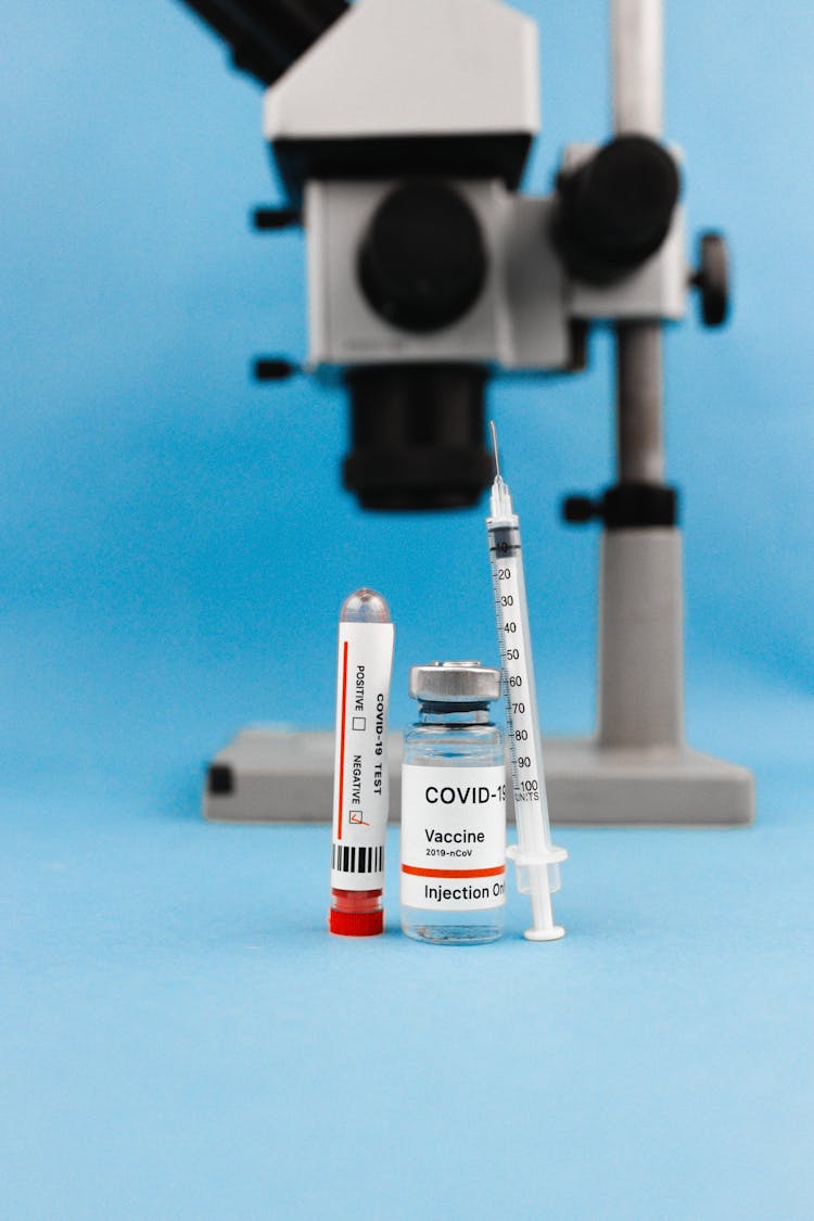 Vaccine Bottle On Blue Table