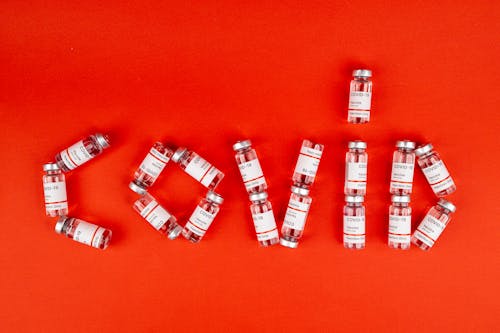 Free Covid Vaccines on a Red Surface Stock Photo