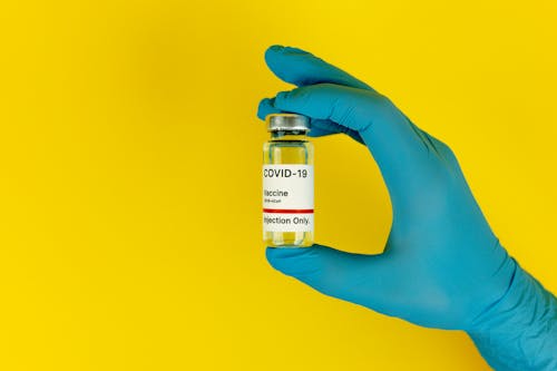 Free Person Holding a Covid Vaccine Stock Photo