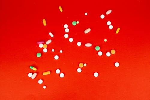 Assorted Tablets on Red Background