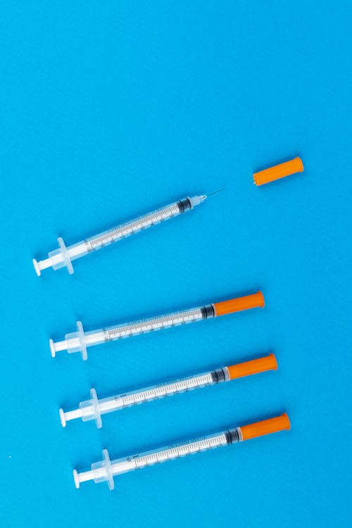 White and Orange Plastic Syringe