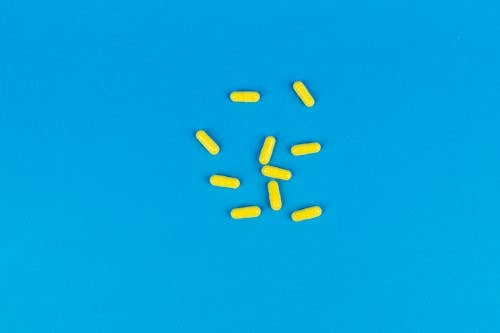 Yellow Capsules on Blue Surface
