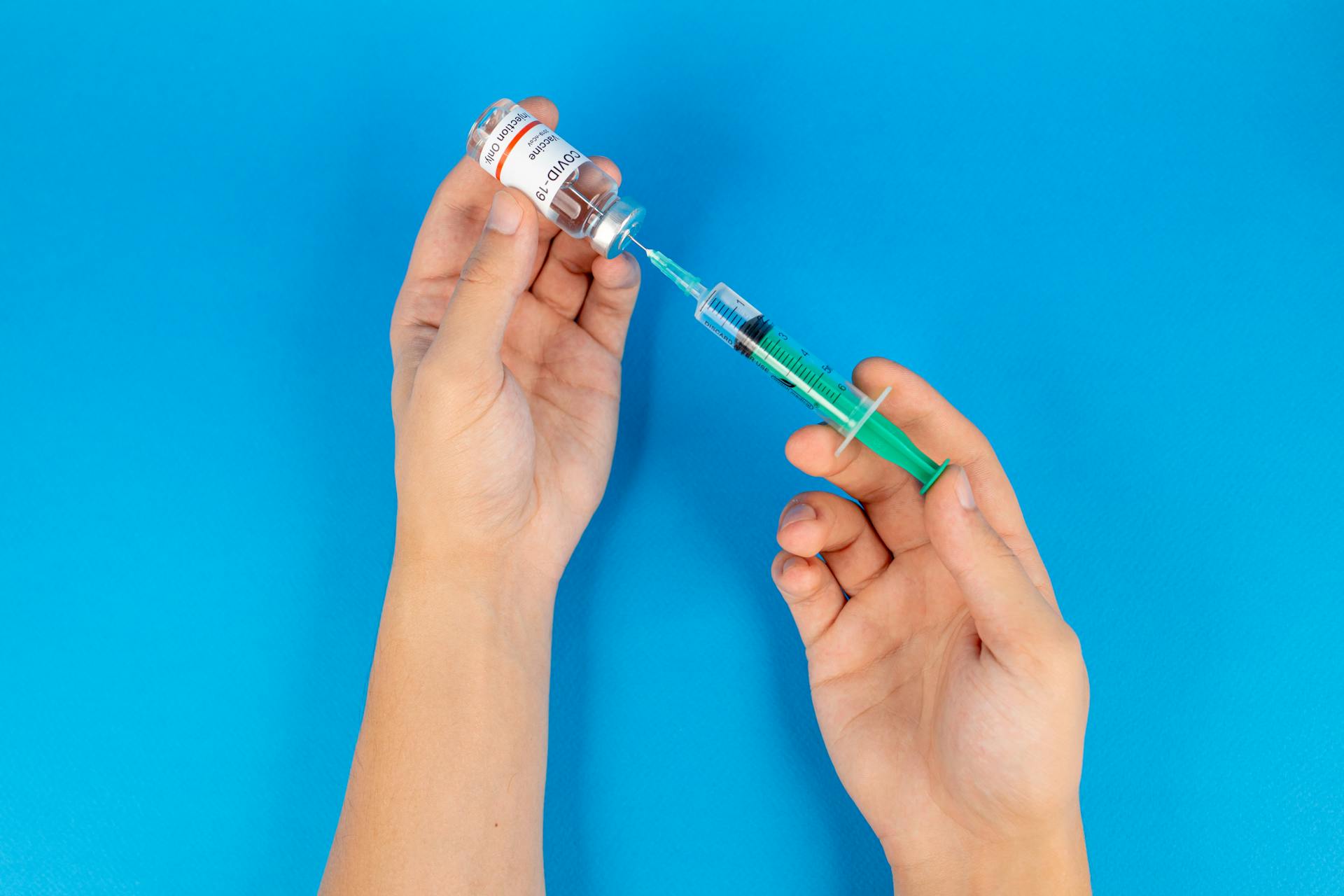 Person Holding a Covid-19 Vaccine