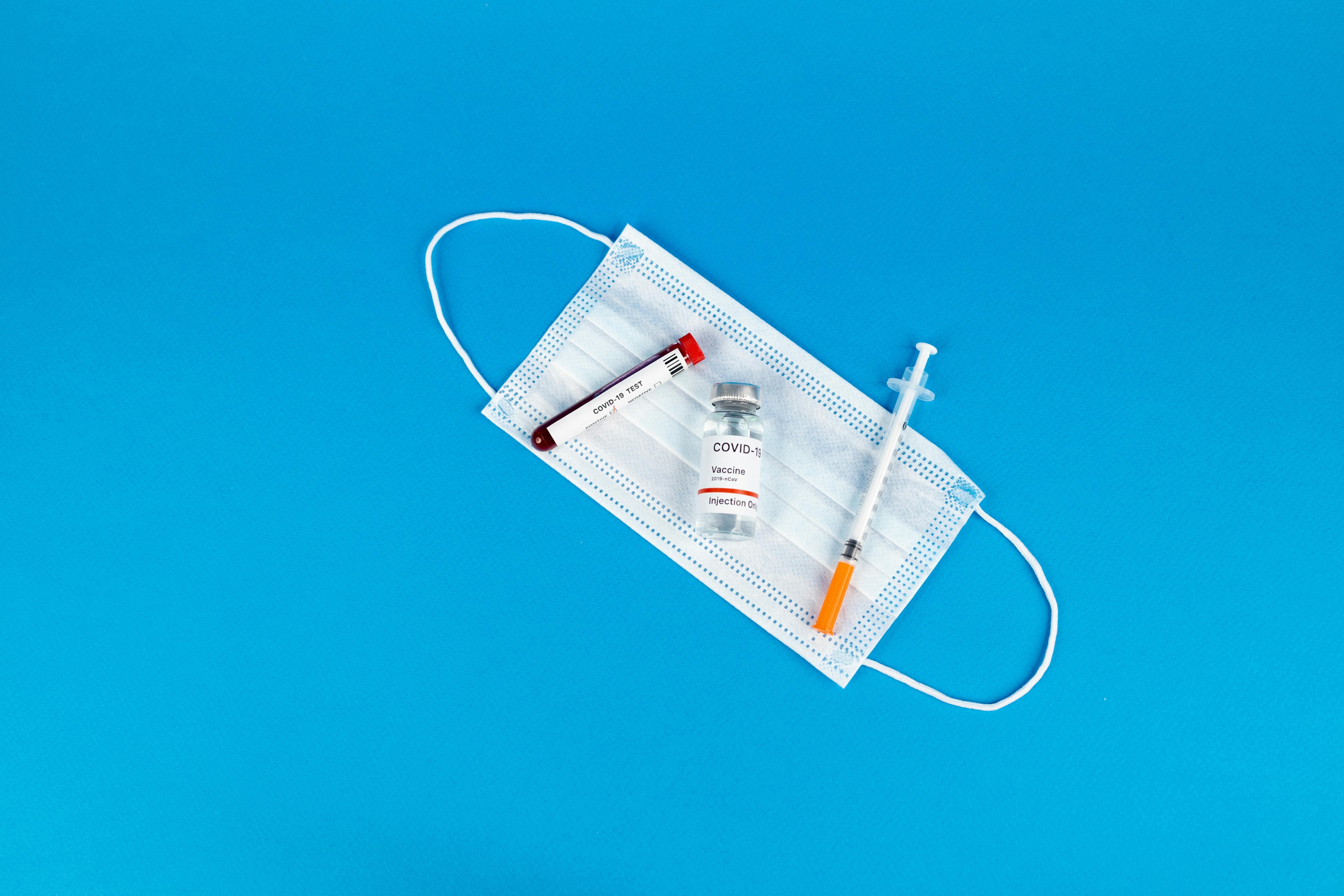 White Face Mask on Blue Background · Free Stock Photo