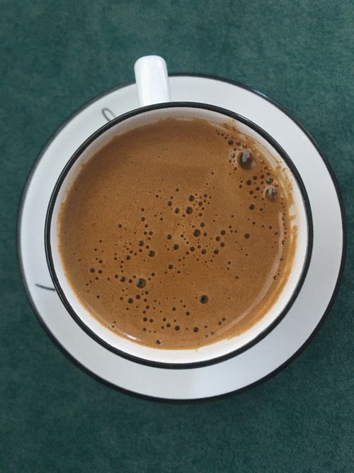 Free Aromatic Turkish coffee served in a white cup with a saucer, perfect for a caffeine boost. Stock Photo