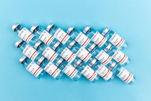 Vaccine Bottles on Blue Background
