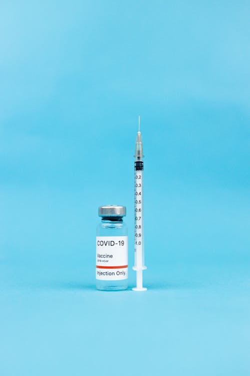 White Syringe on Blue Background