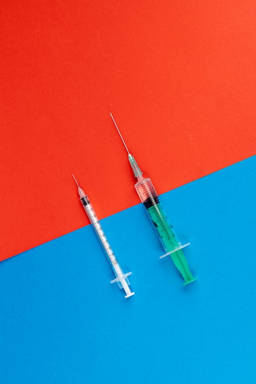 
Syringes on a Red and Blue Surface