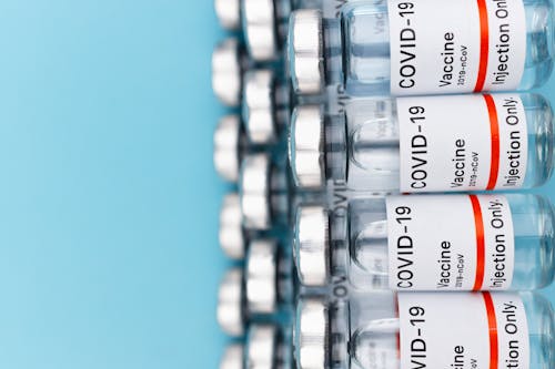 Free Vaccine Bottles in Close Up Photography Stock Photo