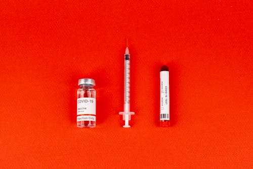 Vaccine Bottle on Red Background