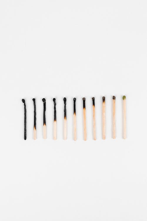 Burnt Wooden Matchsticks on White Background