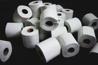 Pile of Toilet Papers on Black Surface