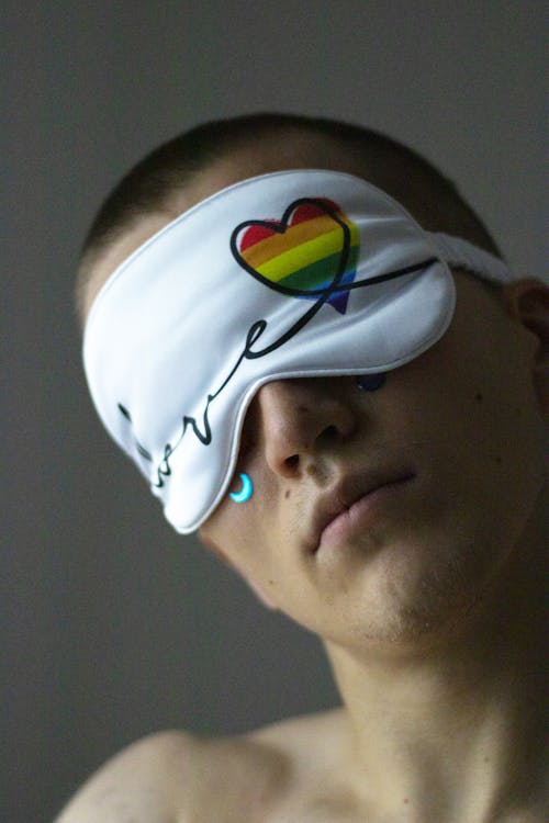 A Man Wearing a White Sleep Mask