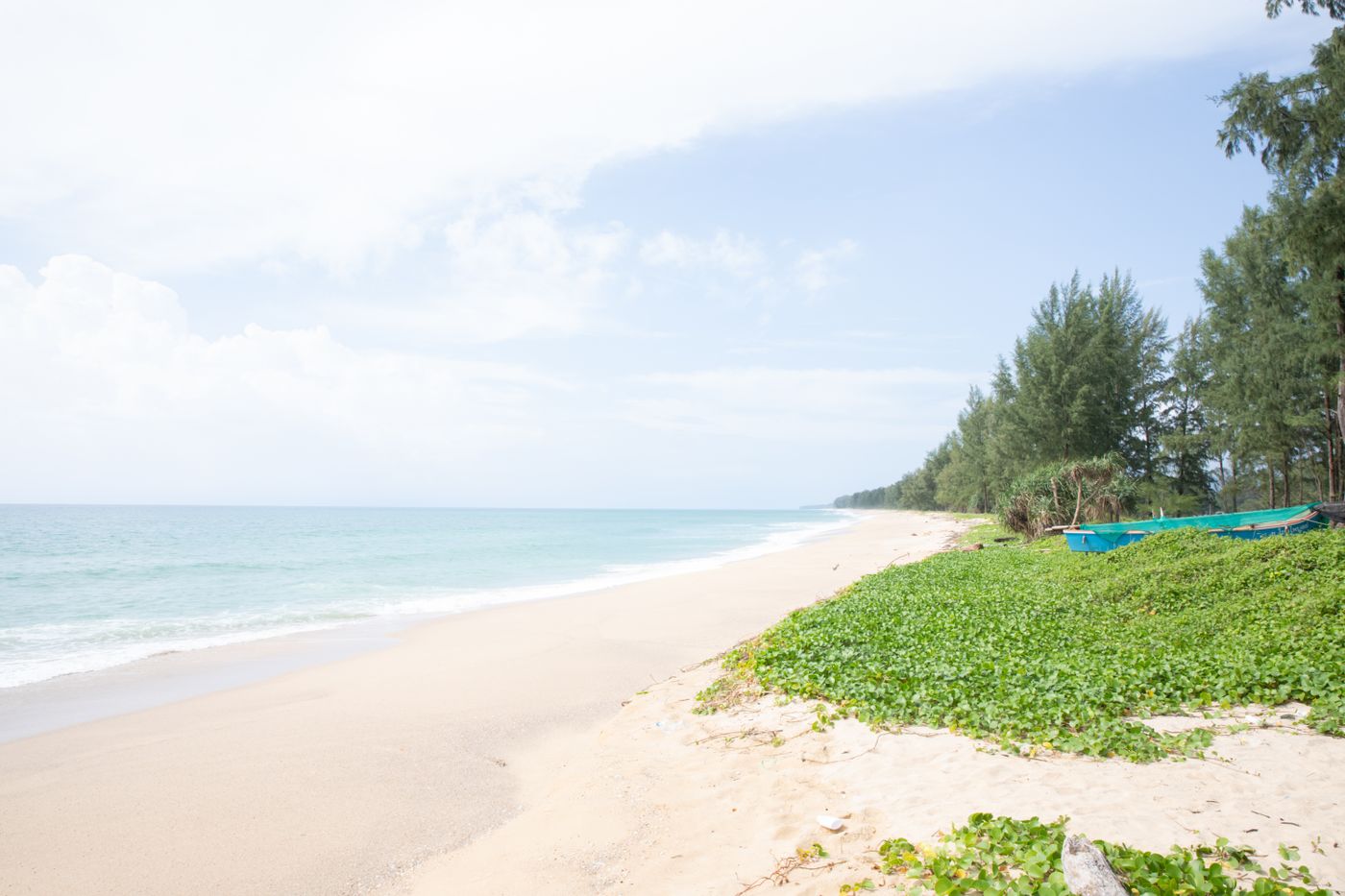 An empty white-sand beach backed by trees at Na Toei, Phang Nga, Thailand