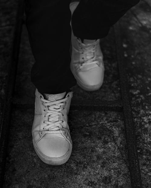 Person Legs Wearing White Sneakers