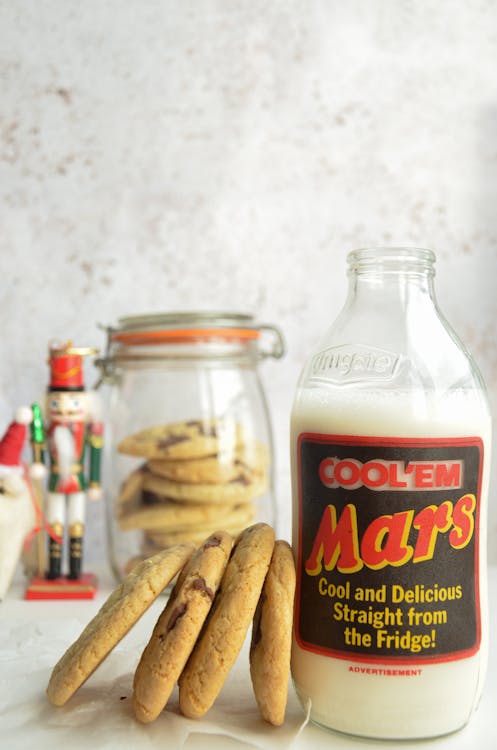 Free Cookies Leaning on Bottle of Milk Stock Photo