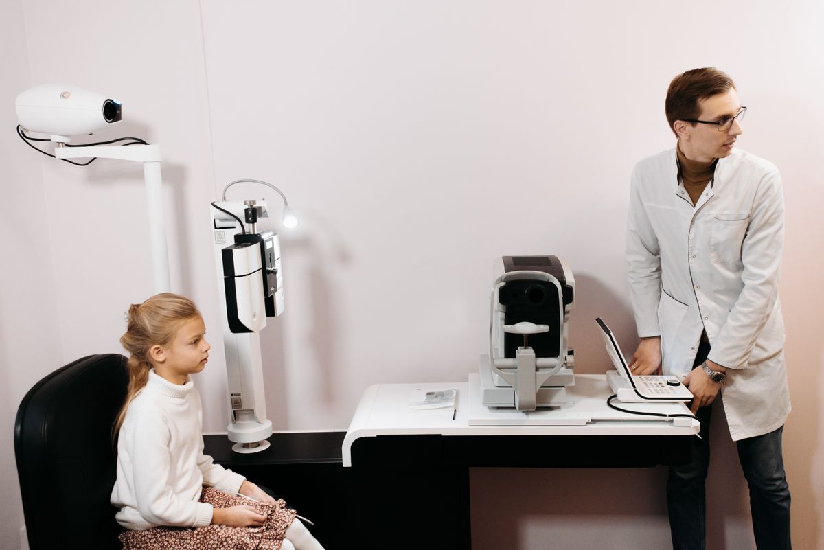 Optometrist performing an eye exam with digital equipment
