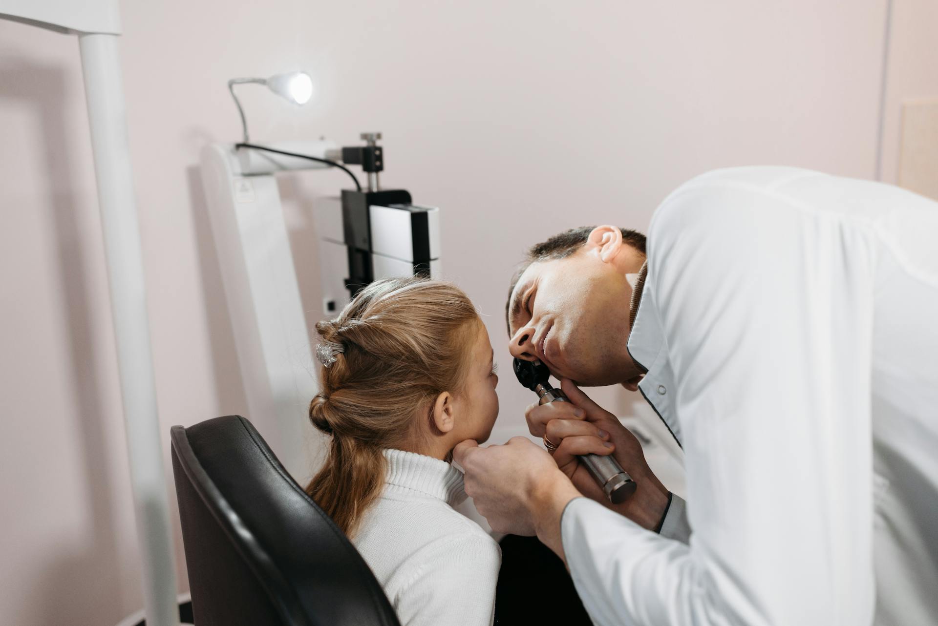 A Medical Practitioner Examining a Girl's Eye