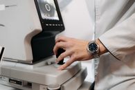 Person in White Dress Shirt Using Black and Gray Treadmill