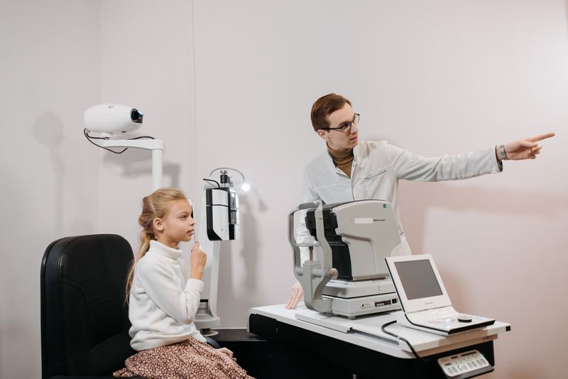 Doctor guiding a young patient through an eye examination