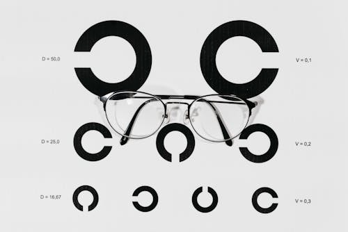 Black Frame Eyeglasses on White Paper With Printed Background