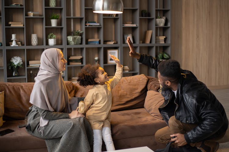 Happy Diverse Family Having Fun Near Couch At Home