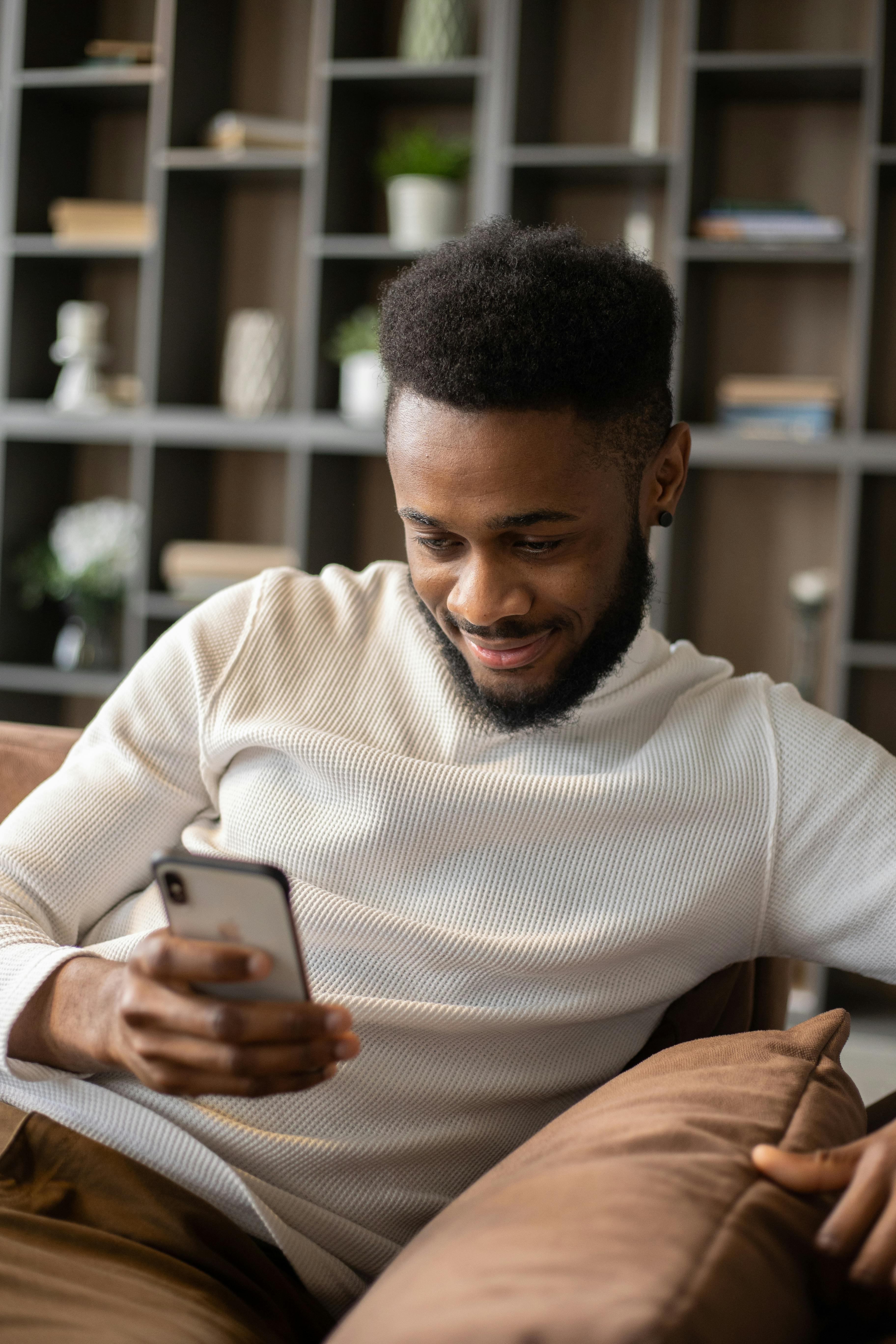 glad black man having video call via smartphone