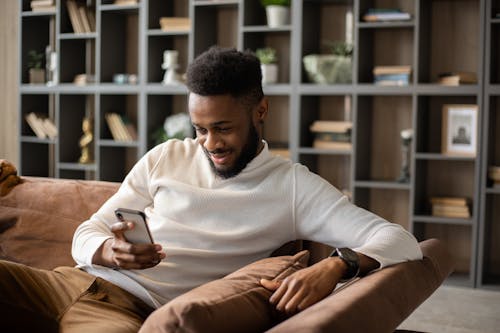 Free Smiling young black man having video call at home Stock Photo