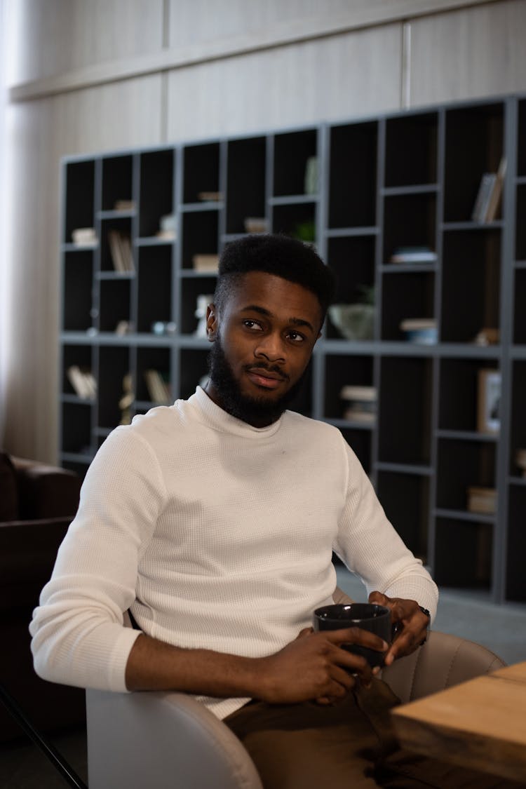 Black Man Drinking Hot Beverage In Morning At Home