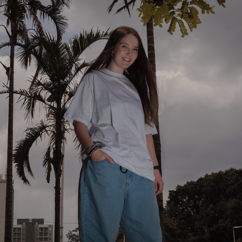 Free Casual portrait of a smiling woman outdoors. Palm trees and denim style in urban setting. Stock Photo
