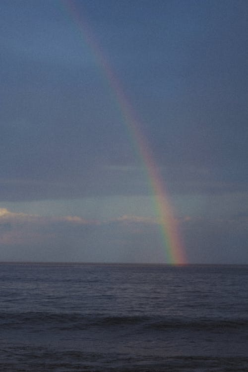 Free Rainbow Over a Body of Water Under Blue Sky Stock Photo