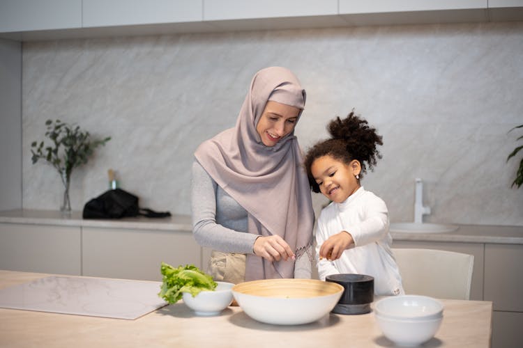 Happy Diverse Mother And Daughter Cooking Together