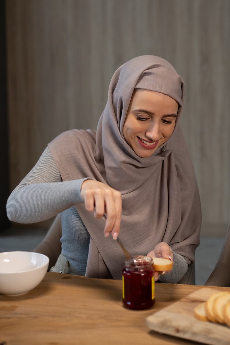 Cheerful Woman Eating Bread With Jam