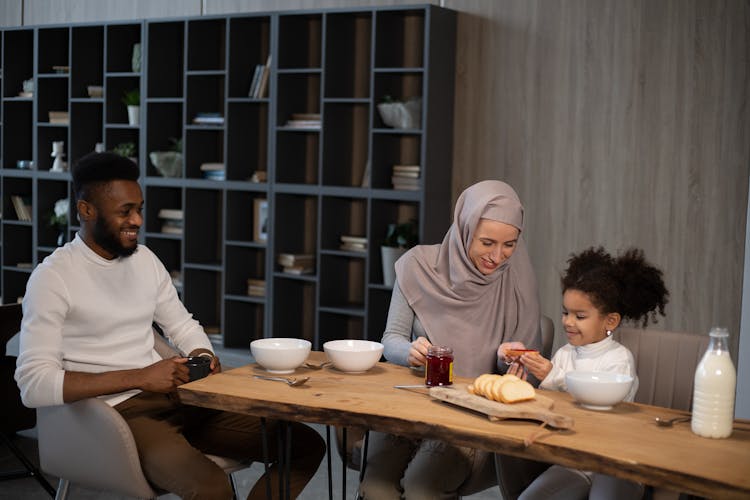 Cheerful Multiethnic Family Having Breakfast Together