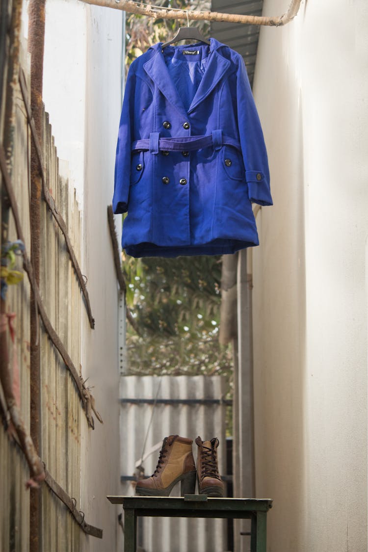 Blue Coat Hanging On A Tree Branch