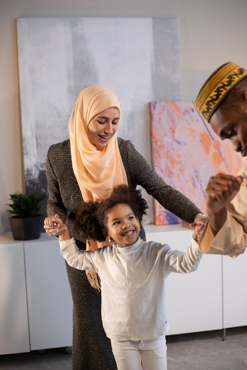 Free Cheerful family dancing and having fun Stock Photo