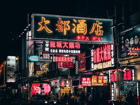 Colorful neon signs illuminate the bustling streets of Hong Kong, showcasing vibrant city nightlife.