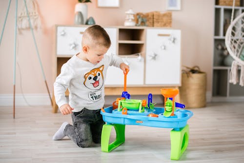 A Young Boy Playing Plastic Toys