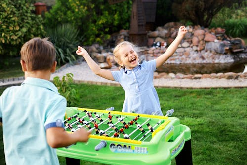A Happy Girl Playing Foosball Table