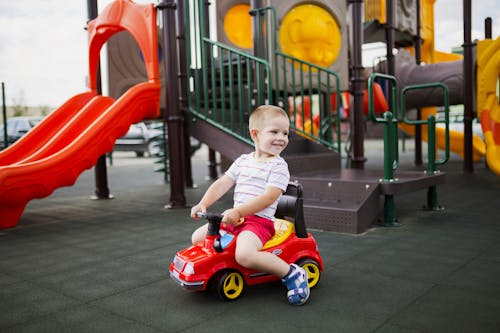 Boy Riding a Push Car