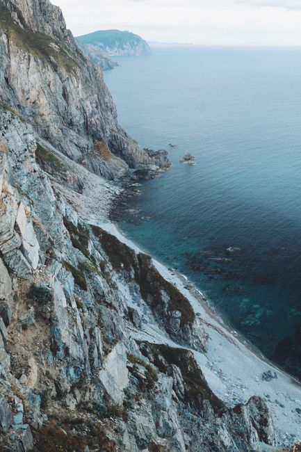 Breathtaking view of rugged cliffs and turquoise waters, capturing the essence of natural beauty and serenity.