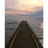 Wooden dock reaching into calm sea, by Alessio Medini on Pexels