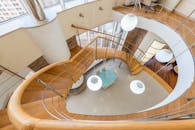 Large stairway leading to first floor of modern spacious apartment with glass walls