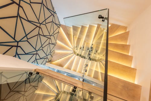 Illuminated stairway with glass railing
