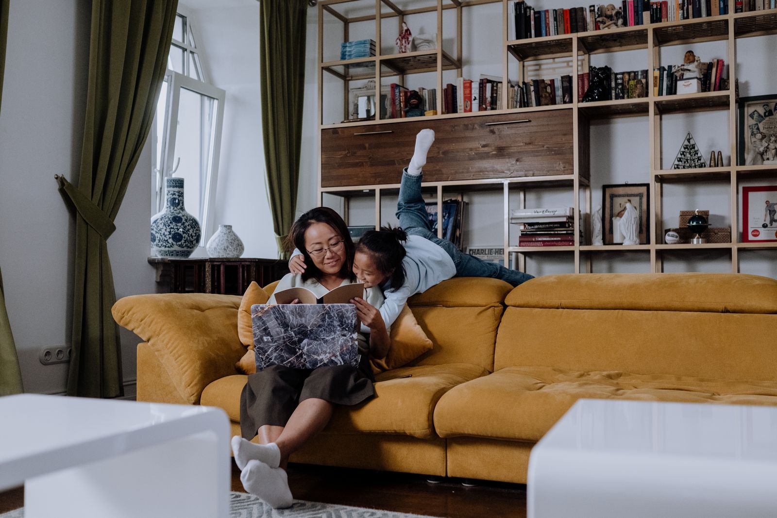 Parent and child reading together on the sofa