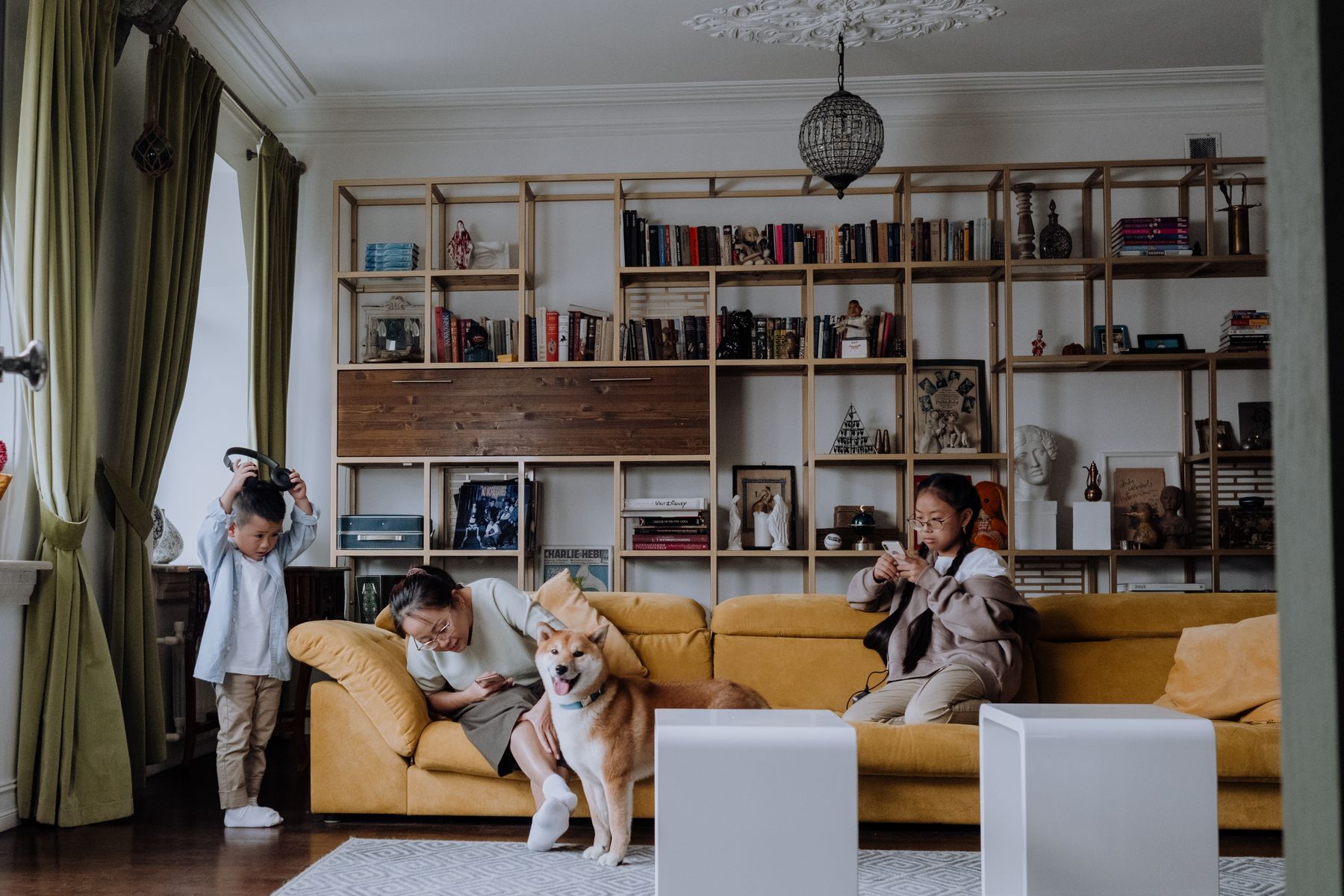 Several people seated in a living room with a dog
